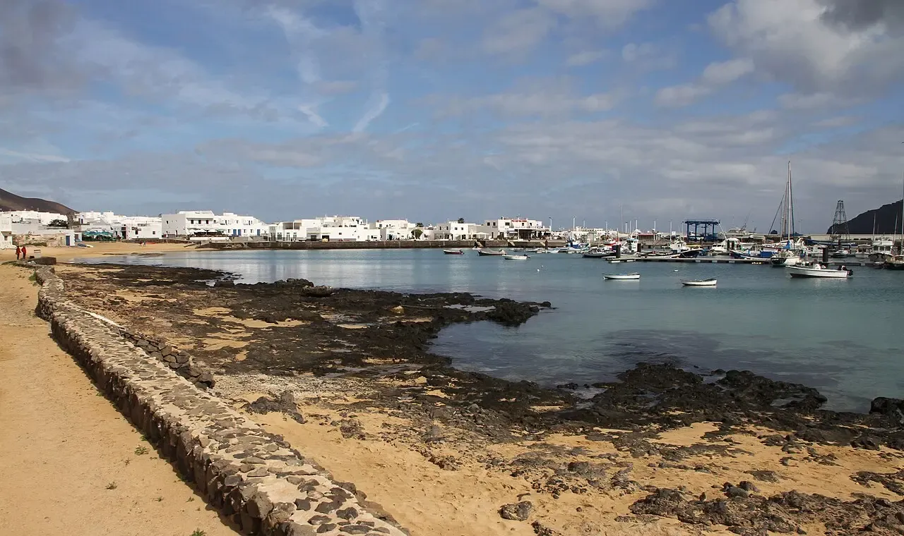 Calle de arena en Caleta de Sebo con casas blancas y detalles azules
