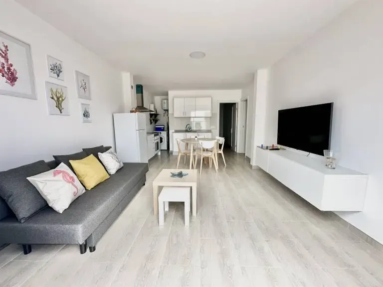 Interior sencillo y luminoso de un apartamento turístico típico en La Graciosa, con cocina integrada